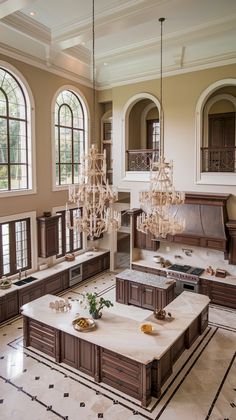 a large living room filled with furniture and chandelier hanging from two ceiling lights