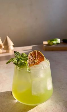 a glass filled with lemonade sitting on top of a table