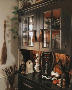 an old china cabinet is decorated with halloween decorations