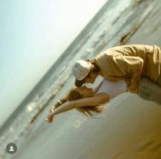 a man and woman are kissing on the beach