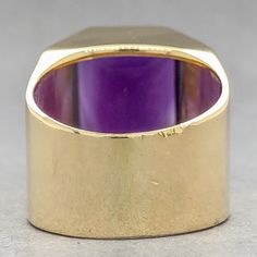 This vintage-inspired Estate 18K Y Gold Amethyst Cocktail Ring puts a modern spin on old-world charm. Featuring a mesmerizing 9.55ct emerald cut amethyst, set in a warm 18k yellow gold band of 16.18mm at the top and 9.57mm at the band, it's a stunning piece that can be sized to your finger! Start a new tradition in timeless luxury. One stamped & tested 18KT yellow gold lady's custom wax & cast gemstone fashion ring with a flat shank with rounded edges with a bright polish finish. The custom made Amethyst Cocktail Ring, Amethyst Set, Timeless Luxury, Fashion Ring, Old World Charm, Gold Band, Cocktail Ring, Cocktail Rings, Emerald Cut