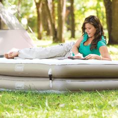 a woman laying on top of an inflatable mattress