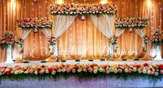 an image of a decorated stage with flowers and candles on the table for a wedding