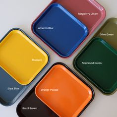 four different colored trays sitting next to each other