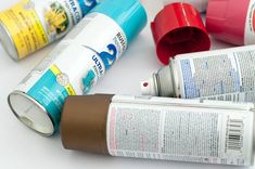 several cans of paint sitting next to each other on a white counter top with the lids off