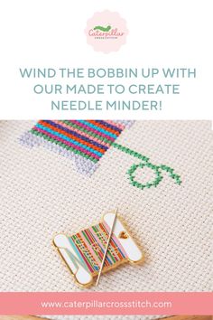 a pin with the words, wind the bobbin up with our made to create needle minder