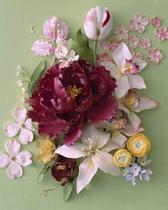 an arrangement of flowers on a green background