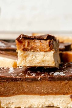 several pieces of chocolate and peanut butter bars stacked on top of each other