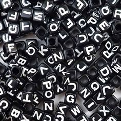 black and white alphabet beads with letters on them