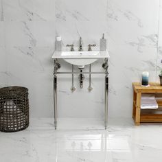 a bathroom with marble walls and flooring, including a white sink in the center