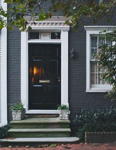 a black front door and steps in front of a house