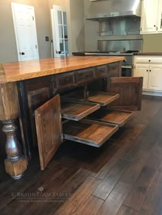 the kitchen island is made out of wood and has two drawers on one side that are open