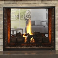 a fire is burning in a fireplace with the reflection of a living room on it