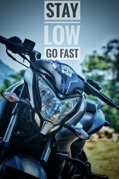 a motorcycle with the words stay low go fast on it's headlight and handlebars