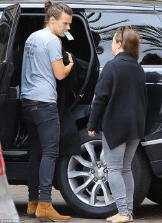 two women are getting out of the car