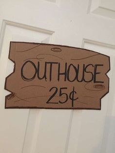 a sign that says outhouse 250 is hanging on the door