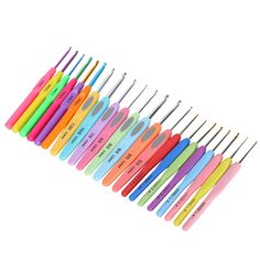 there are many different colored toothbrushes lined up in a row on the white background