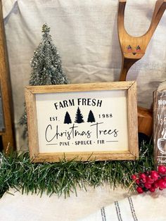 a wooden sign sitting on top of a table next to christmas decorations and other items