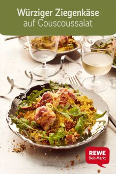 an image of a plate of food on a table with wine glasses and utensils