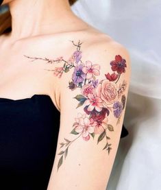 a woman's shoulder with flowers on it