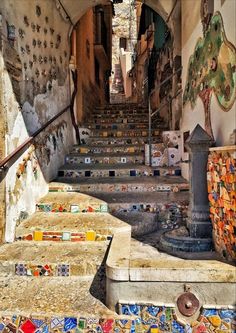 an old set of stairs with colorful tiles on them