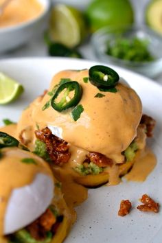 some food is on a white plate with limes and other foods in the background