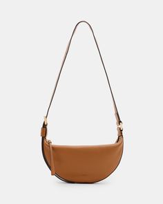 An essential shape - this is the Half Moon Crossbody Bag. Crafted from leather and shaped to a compact crescent silhouette with plenty of space on the inside. It's finished with an adjustable strap that makes it super easy to wear.  Zip closure Adjustable strap Metal hardware Two interior pockets Will fit the largest size iPhone - please check measurements Modern Allsaints Crossbody Shoulder Bag, Allsaints Crossbody Shoulder Bag, Allsaints Shoulder Bag With Removable Pouch For Everyday, Allsaints Shoulder Bag With Adjustable Strap For Everyday, Allsaints Casual Shoulder Bag With Adjustable Strap, Bag Light, Boots And Sneakers, Sweaters And Jeans, Sneaker Heels