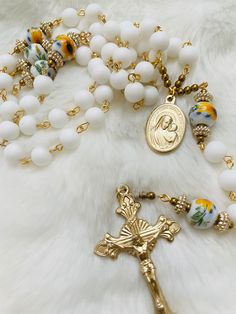 This is a handmade rosary. Beads used are 8mm. White opaque glass for Hail Mary and Rose decorated Glass for Our Father. Each piece is carefully crafted to ensure all links are closed. Each piece comes with a storage pouch. Thank you for your support! Part of the profit from these rosaries will go towards our kids' Catholic Education. Please help us pray that they may choose a good and Holy vocation in God's perfect time! Pretty Rosary, Rosary Collection, Our Lady Of Good Counsel, Diy Rosary, Flower Rosary, Our Lady Of Grace, Handmade Rosary, Catholic Education, Pearl Rosary