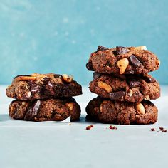 three cookies stacked on top of each other with chocolate chips and nuts in the middle