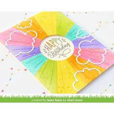 a card with the words happy birthday on it and rainbows in the sky behind it