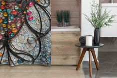 a bathroom with a shower curtain decorated with colorful stones