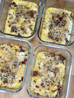 four glass casserole dishes filled with food on top of a wooden countertop