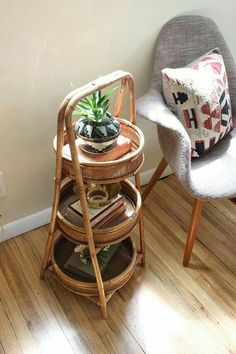 two chairs and a table with a potted plant on it