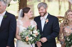 a bride and groom standing next to each other with their bridal party in the background