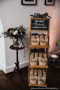 a wooden stand with coffee bags and flowers on it