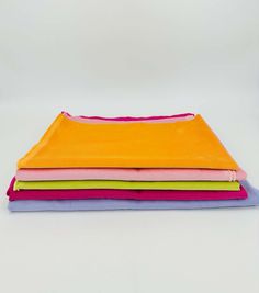 five different colors of cloth stacked on top of each other in the same row,