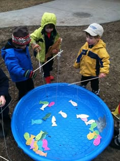 three children are playing with an upside down frisbee