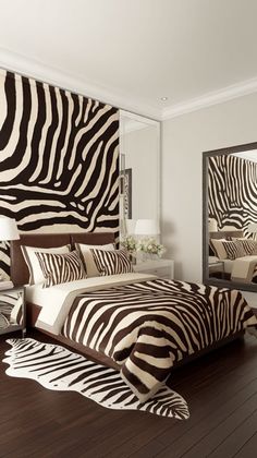 a zebra print bed in a bedroom with mirrors on the wall and wooden flooring