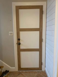 an open door in a room with tile flooring and white paint on the walls