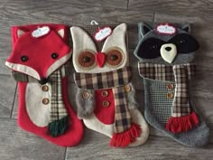 three christmas stockings with animals on them are sitting on the floor next to each other