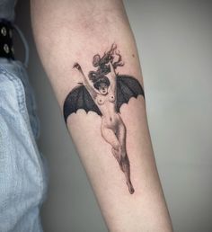 a woman with a bat tattoo on her arm