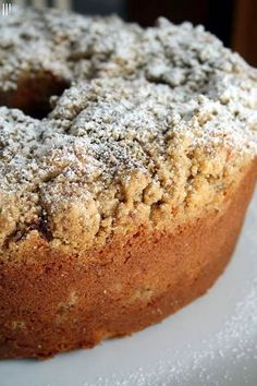 a close up of a cake on a plate with powdered sugar over the top