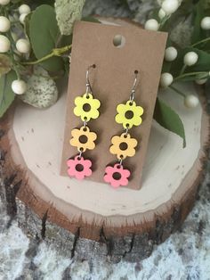 Wood earrings are so trendy right now. And this flower dangle earring is perfect for any season! It is the perfect accessory to complete any outfit. This earring measures 2.5x.5 inches. Choose between 2 color sets.  Great for those who need a hypoallergenic option!  Ships free in the USA Flower Power Wood Earrings, Playful Flower-shaped Spring Earrings, Orange Flower-shaped Earrings For Summer, Multicolor Flower-shaped Artsy Earrings, Yellow Flower-shaped Earrings, Wood Earrings, Simple Earrings, Etsy Earrings Dangle, Cut Flowers