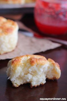 two pieces of biscuit sitting on top of a wooden table