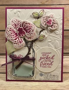 a card with flowers in a mason jar