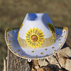 Sunflower Cowboy Hat with metal eagle, sequins patches, sequins, rhinestones, and fringe. Color: White Only Size: One size fits most adult heads. Measurement: Approximately 22 inches (57 cm) in diameter. Gold Festival Hats For Spring, Adjustable Gold Hat For Carnival, Spring Festival Costume Hat With Short Brim, Adjustable Felt Hat For Summer Party, Adjustable Bohemian Hat For Carnival, Adjustable Country Style Hat Bands For Party, Adjustable Mini Hat With Round Crown For Festival, Gold Country Style Festival Hats, Adjustable Handmade Hats For Carnival