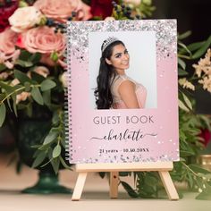 the guest book is on top of a wooden easel with flowers in the background