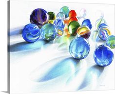 colored glass marbles sitting on top of a white surface