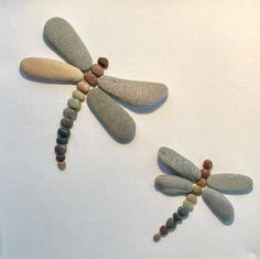 two dragonflys made out of rocks and stones