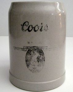 a close up of a canister on a white surface with the word coors printed on it